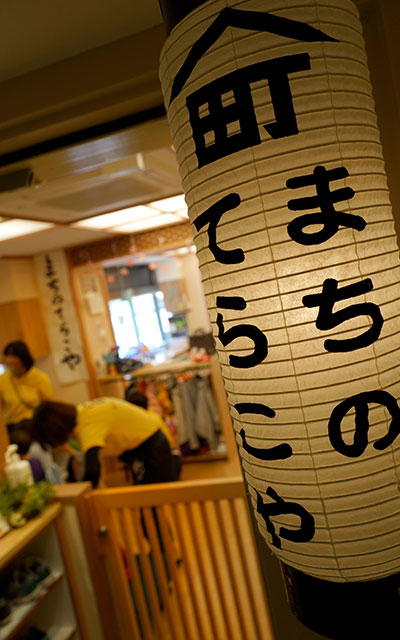 瓦の小庇と漆喰のなまこ壁で仕上げたエントランス。切長型提灯は地元で調達。